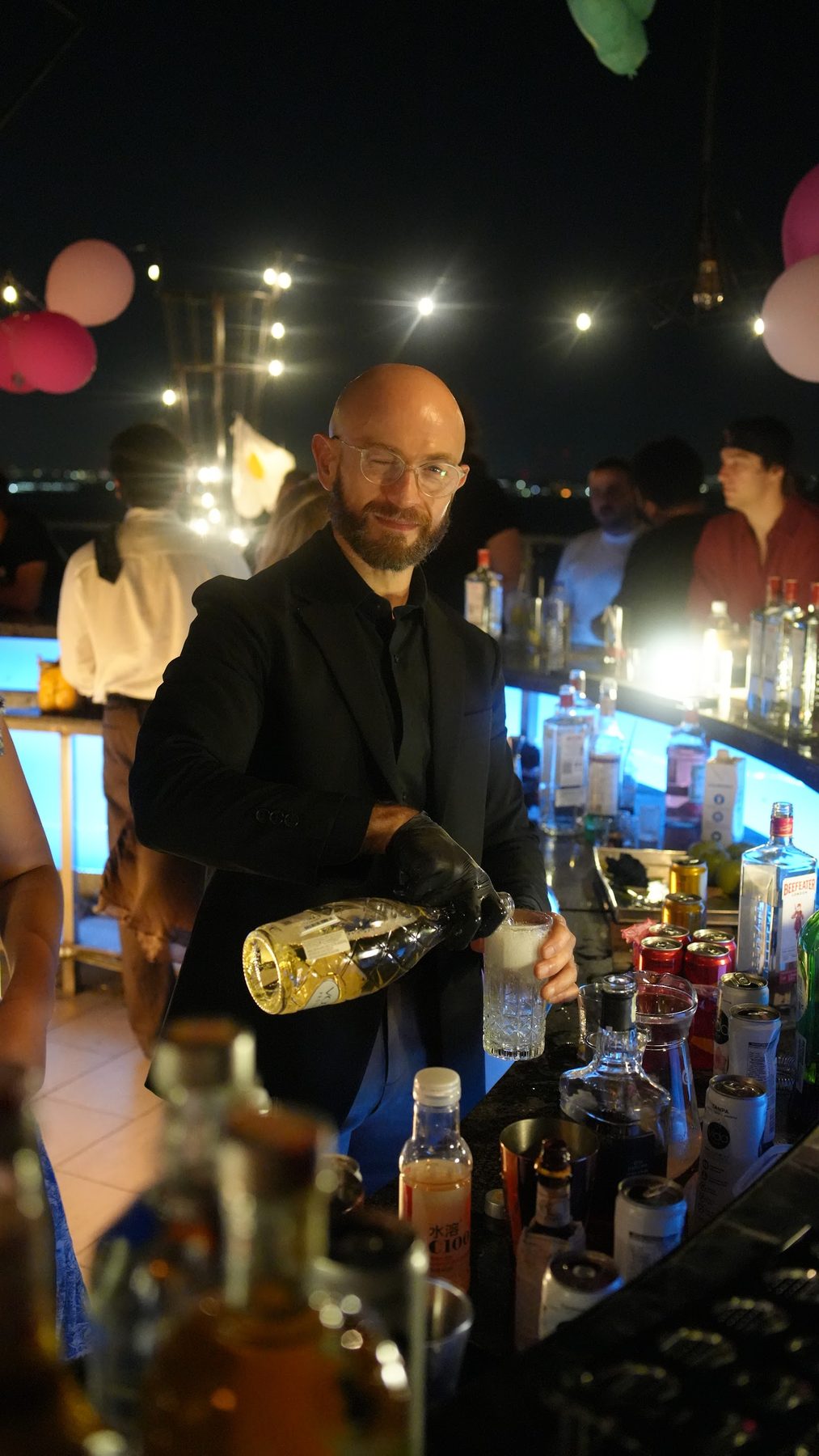Pouring, black suit and gloves